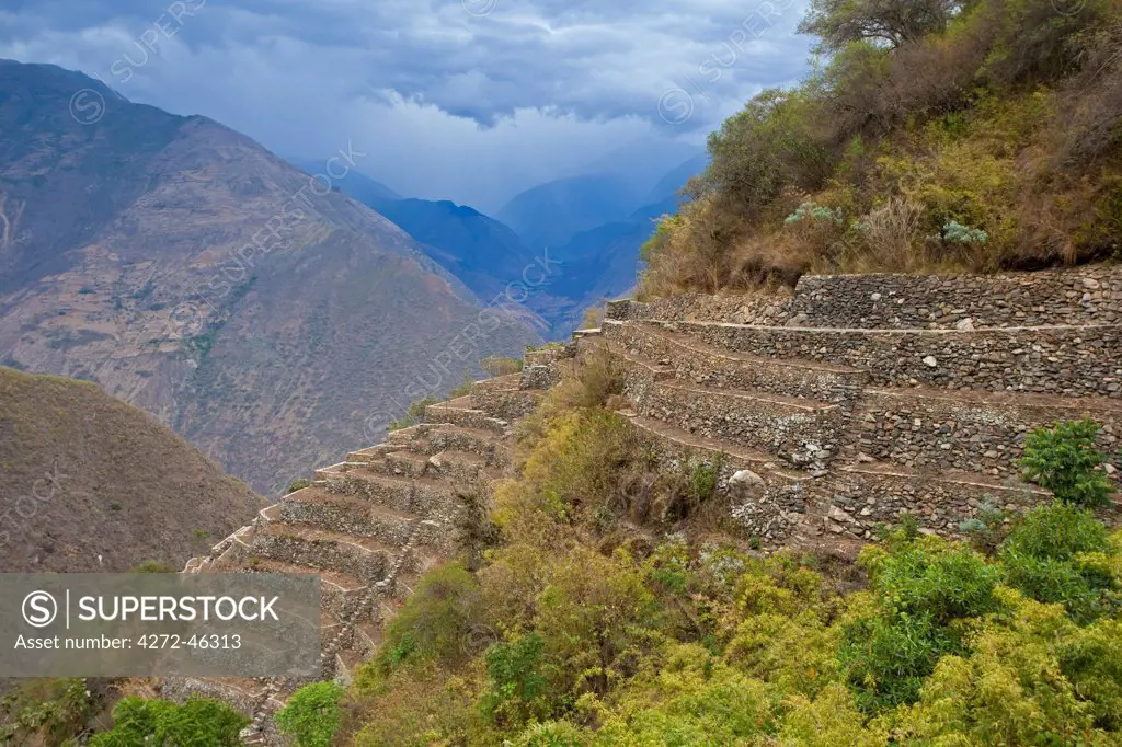 South America, Peru, Cusco, Choquequirao. Threatening clouds over agricultural terraces at the Inca city of Choquequirao built by Tupac Inca Yupanqui and Huayna Capac and situated above the Apurimac valley with mountains of the Salkantay range