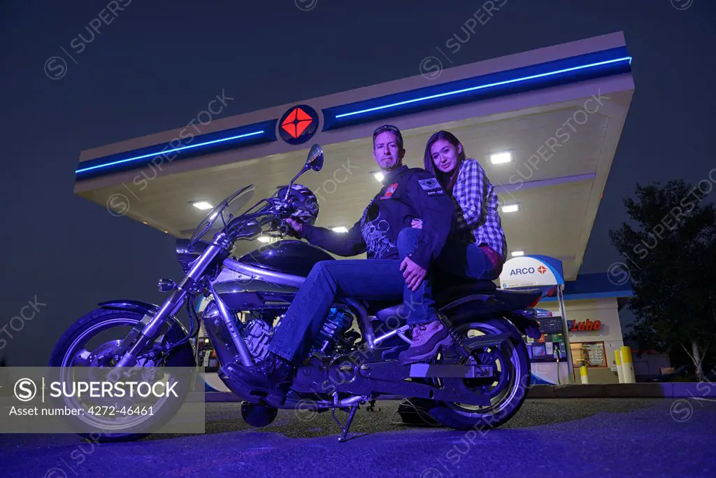 Couple riding a Harley on Highway 20, Bend, Deschutes County, Oregon, USA  MR