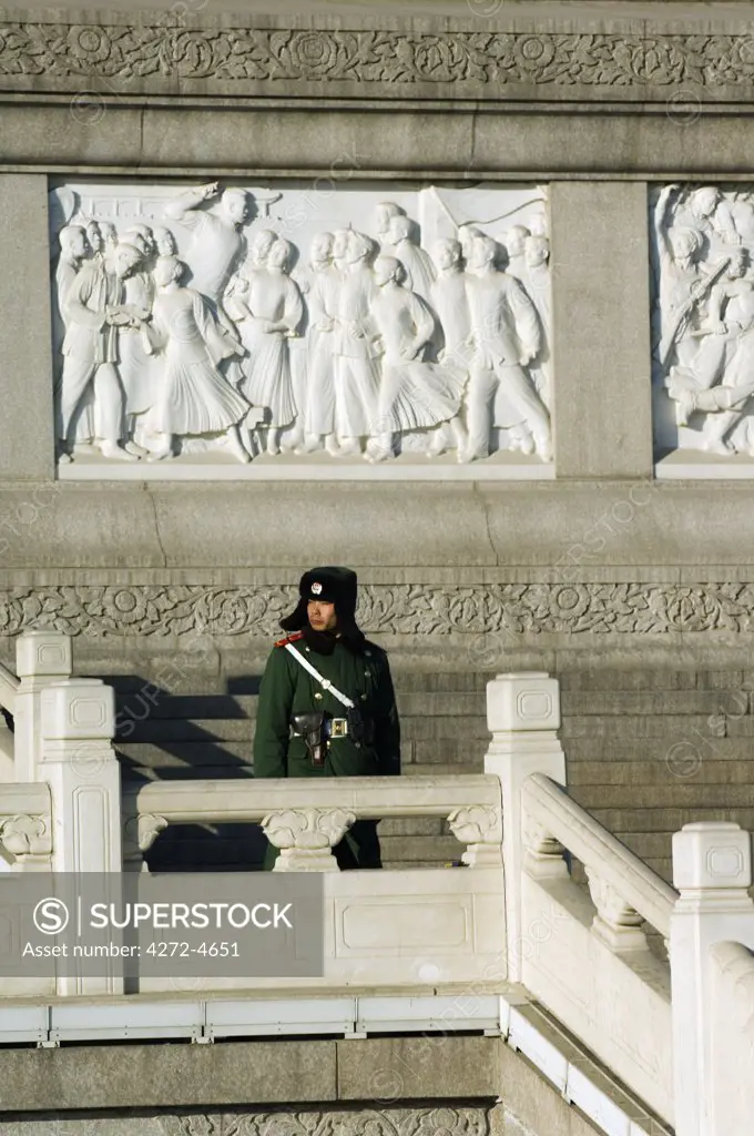 China, Beijing. Tiananmen Square. A guard on duty in front of a communist monument.