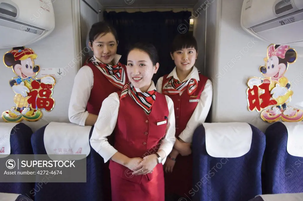 China, Beijing. Chinese New Year - Flight attendants on a New Years Eve flight carrying passengers back to their home towns.