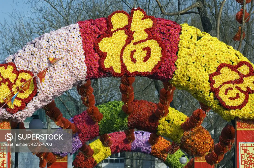 China, Beijing. Chinese New Year Spring Festival - flower decorations for good luck and fortune at a temple fair.
