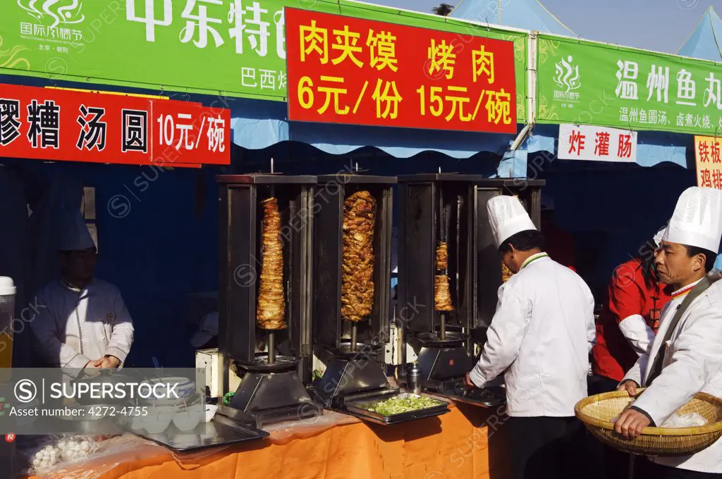 China, Beijing. Chinese New Year Spring Festival A chef preparing food on a Kebab stand at Chaoyang Park Fair