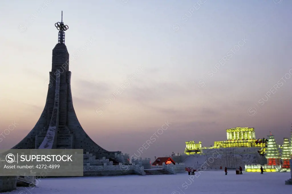 China, Northeast China, Heilongjiang Province, Harbin City. Ice Lantern Festival. Replica of Bangkok's Wat Po and other ice sculptures illuminated at night