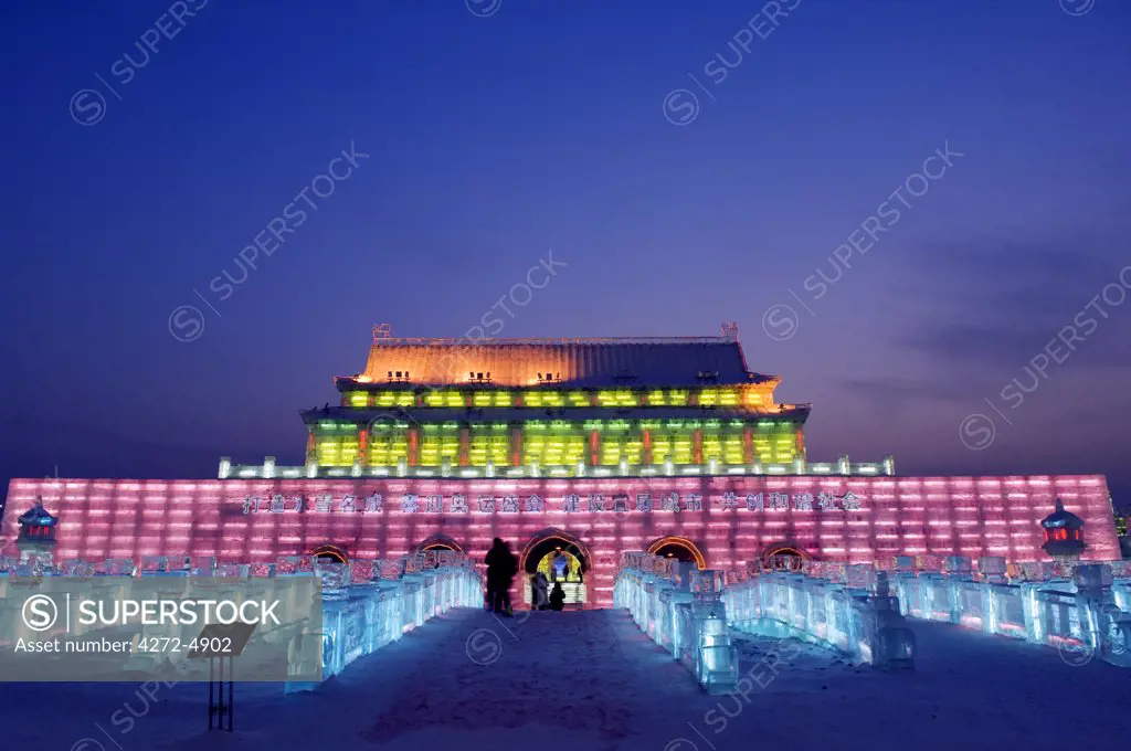 China, Northeast China, Heilongjiang Province, Harbin City. Ice Lantern Festival. A colourful ice sculpture replica of the Forbidden City's Gate of Heavenly Peace in Beijing illuminated at night
