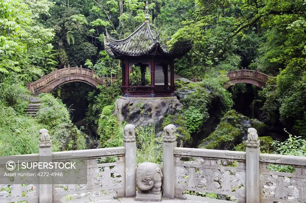 China, Sichuan Province, Mt Emei Unesco World Heritage site. A double arched bridge and pavilion.