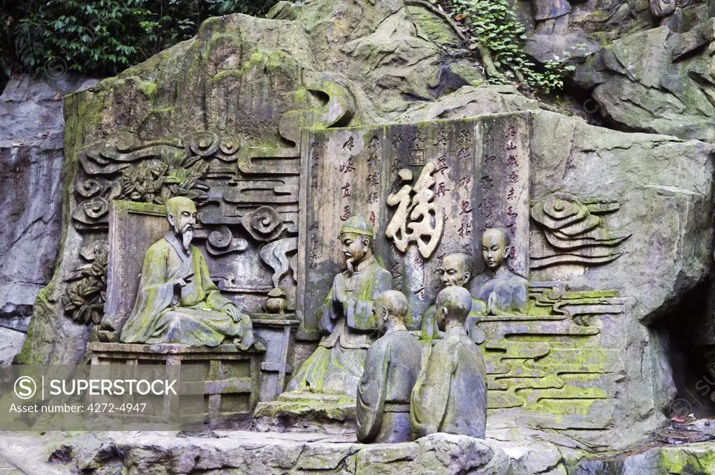 China, Sichuan Province, Mt Emei Unesco World Heritage site. Stone sculpture rock carvings of an ancient priest