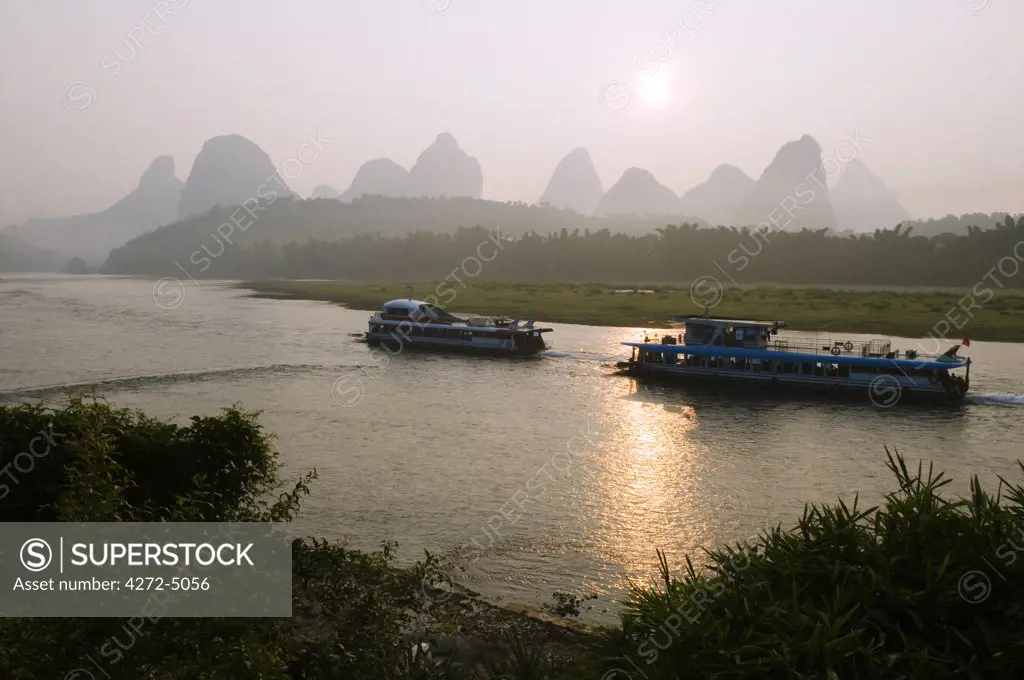 China, Guangxi Province, Yangshuo, near Guilin. Sunrise over karst limestone mountain scenery on the Li River