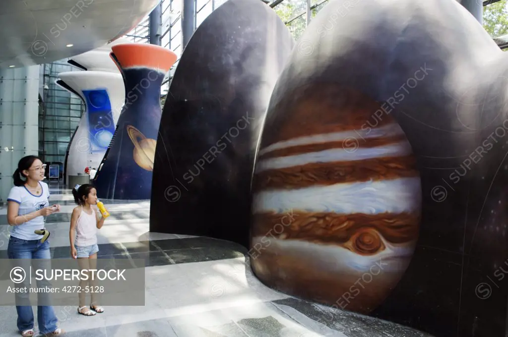 China, Beijing. Visitors looking at a display at the Planetarium Museum
