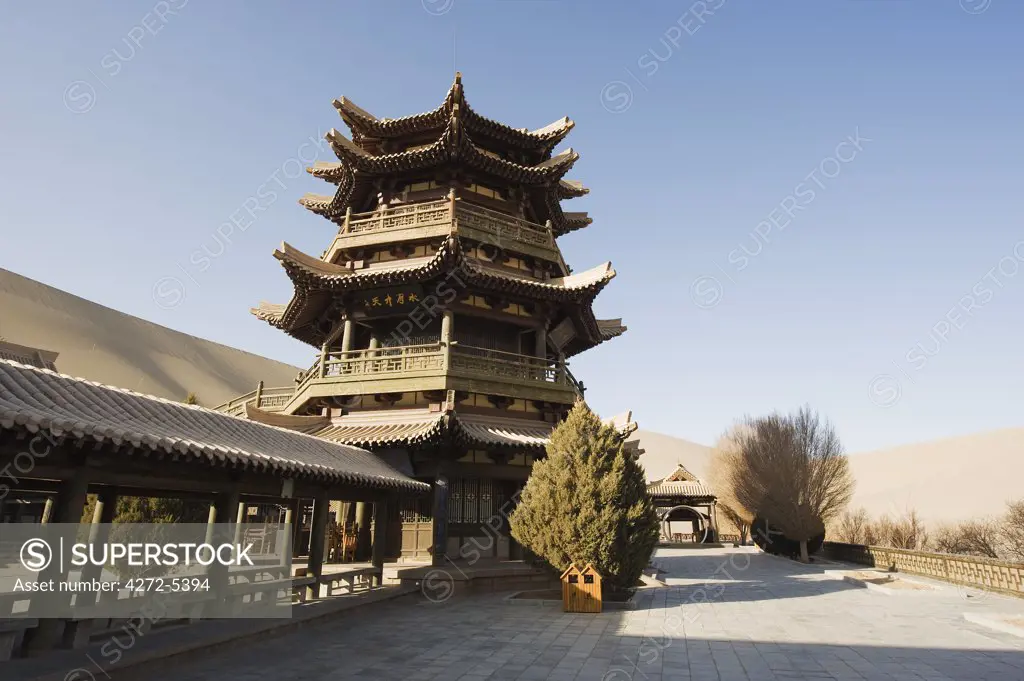 China, Gansu Province, Dunghuang, Ming Sha sand dunes and pavilion at Crescent Moon Lake