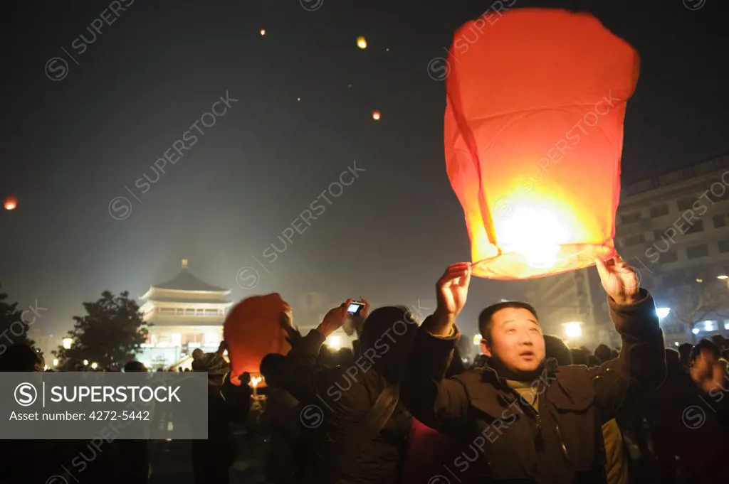 China, Shaanxi Province, Xian, lanterns being released into the sky on New Years Eve