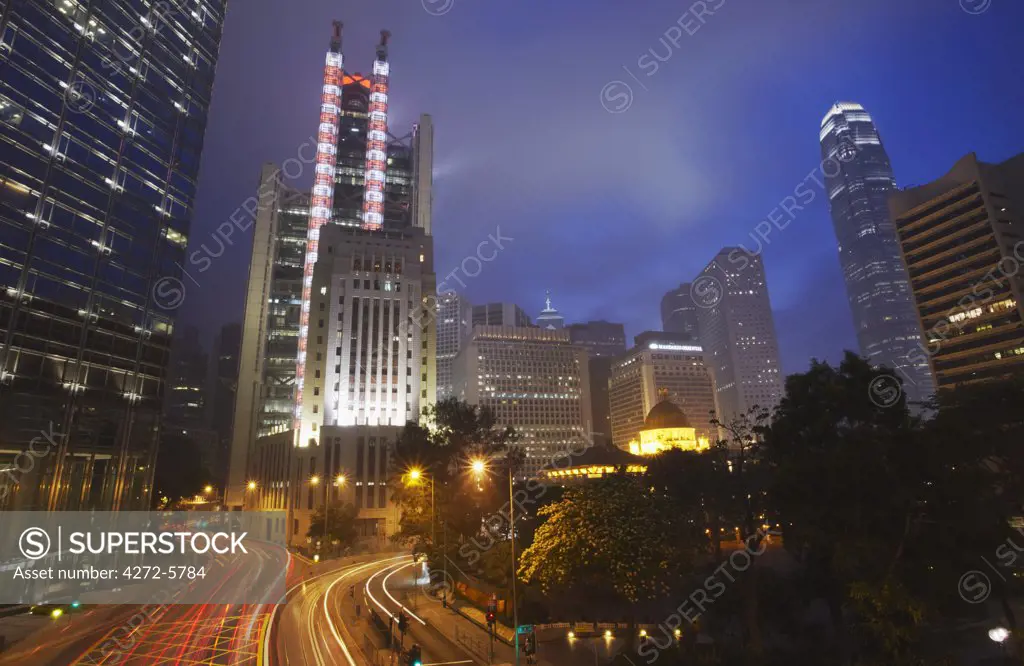 Traffic passing along Queen's Road Central at dusk with HSBC building in background, Central, Hong Kong, China