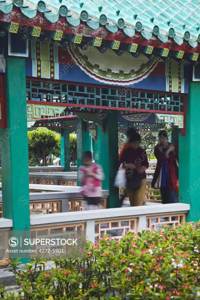 People walking in gardens of Wong Tai Sin temple, Kowloon, Hong Kong, China
