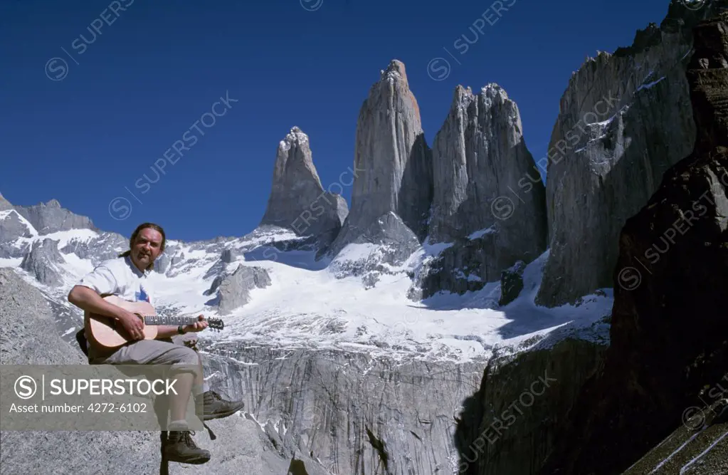 Playing guitar in front of the Towers of Paine