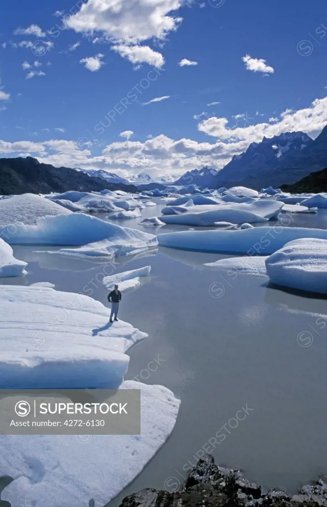 Trekker on iceberg, Lago Grey, Torres del Paine National Park