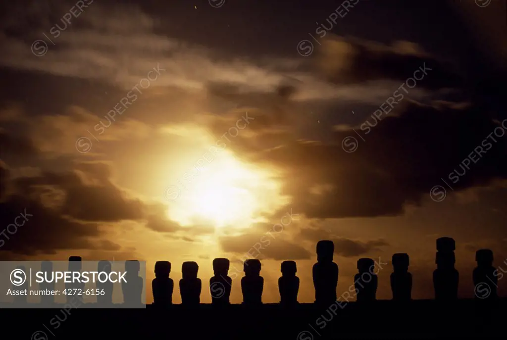 Moonrise over the fifteen colossal stone statues or moais of Tongariki. The moais stand on their platform or ahu on the eastern coast of the island at the foot of the Poike Peninsula.   The vast majority of Easter Islands 800 moais were chiselled out of the volanic tuff on the side of Rano Raraku between 700 to 1500AD.