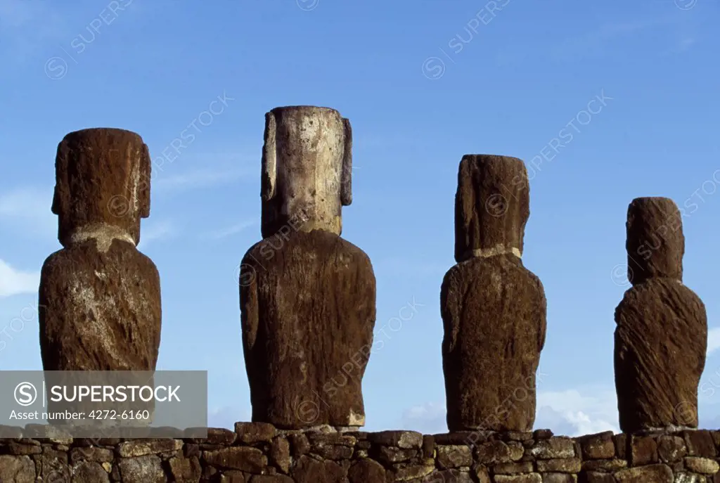 Four of the fifteen colossal stone statues or moais of Tongariki viewed from behind, seaward side.  The moais stand on their platform or ahu on the eastern coast of the island at the foot of the Poike Peninsula.   The vast majority of Easter Islands 800 moais were chiselled out of the volanic tuff on the side of Rano Raraku between 700 to 1500AD.