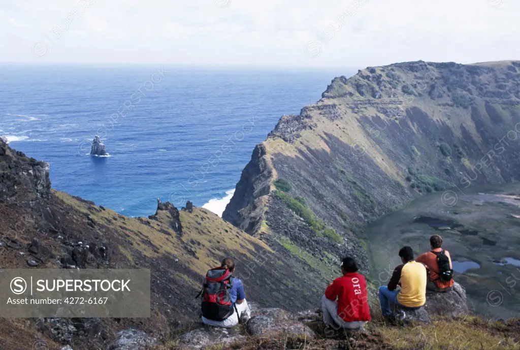 Tourists on the rim of the crater of Rano Kau volcano at the south western tip of Easter Island.