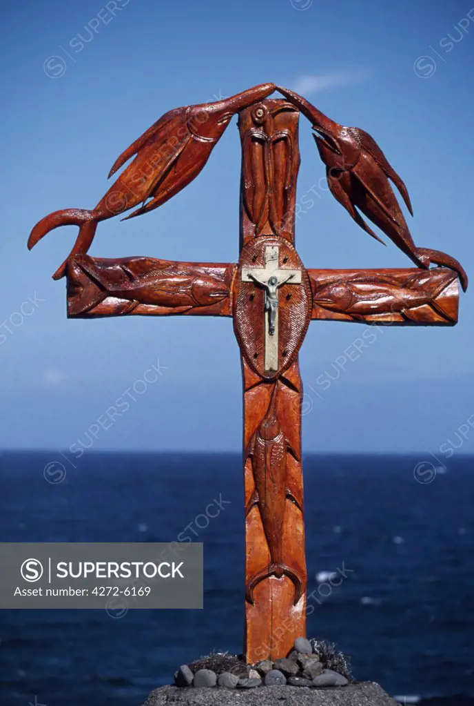 Wooden cross on erected on the southern coast combining the Christian crucifix with carved emblems of the fish from the surrounding sea