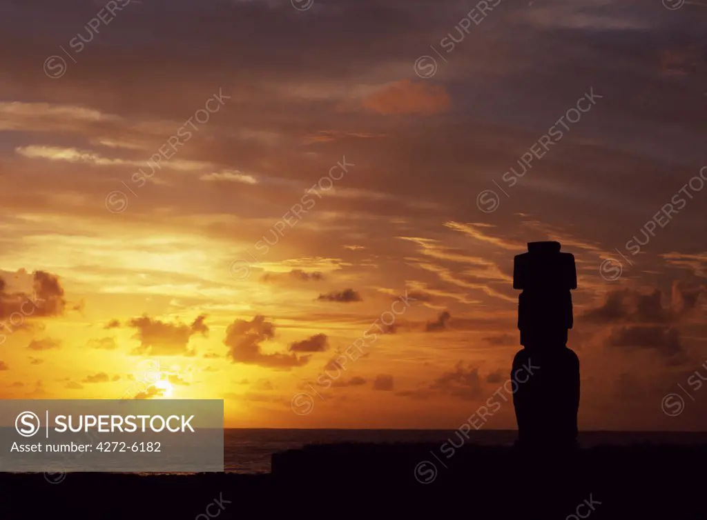Silhouetted at sunset on Ahu Kote Riku, a single well preserved moai sits on top of one of the three ahus or platforms of the ceremonial centre of Tahai.  Tahai is just a short walk from Hanga Roa, the island's main settlement.