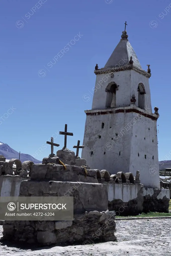 The pretty Andean church at the village of Isluga.  Built in the 17th century, the church has thick, whitewashed adobe walls.  Both church and houses in the village remain locked for most of the year in an abandoned village, the inhabitants return only for religious ceremonies and festivals.