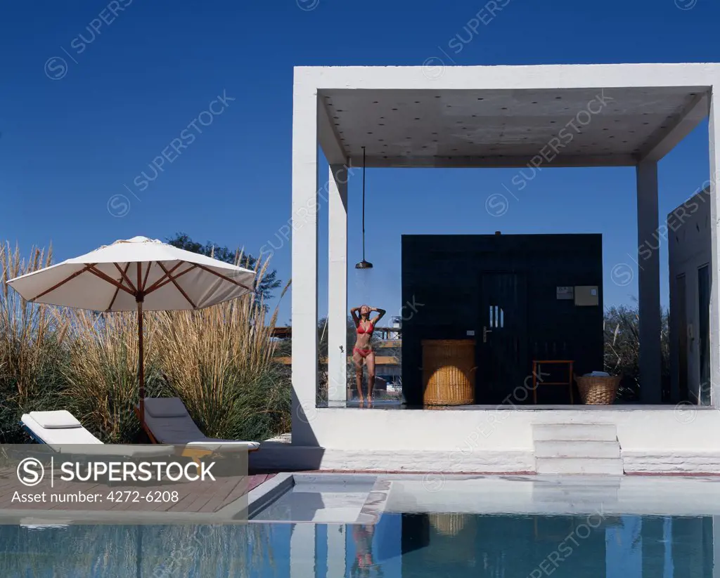 A girl takes a shower beside the sauna at one of the four swimming pools at the Explora Hotel in the Atacama Desert