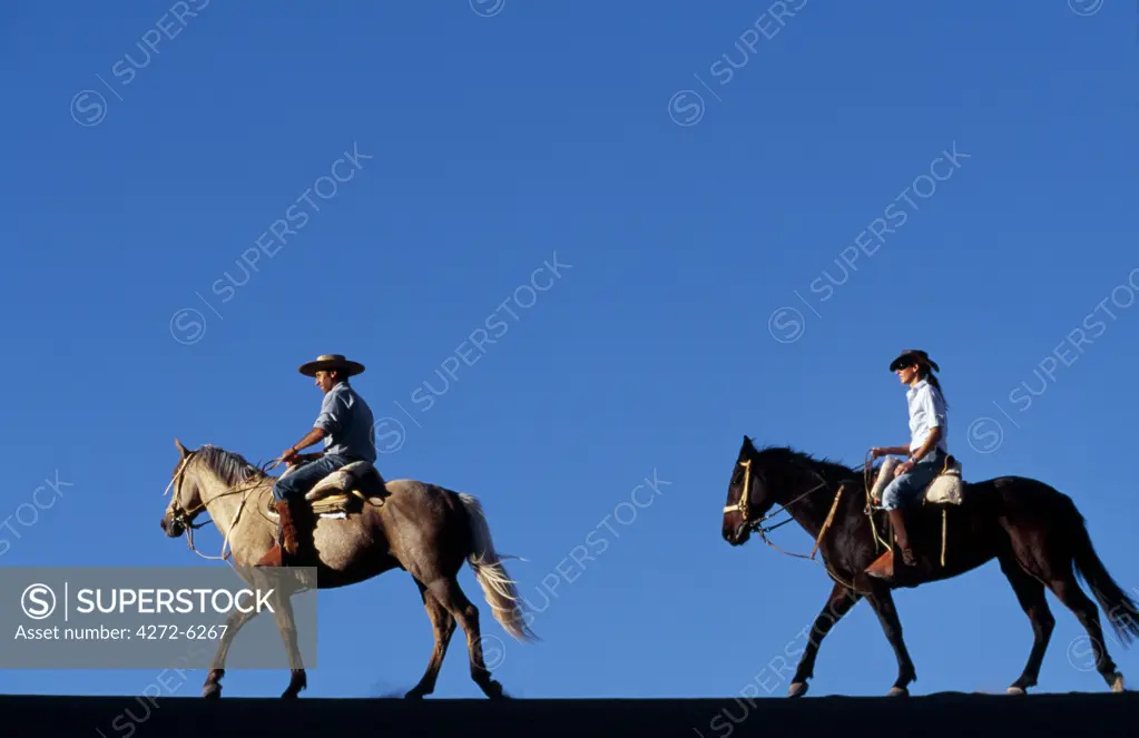 Horse riding along a ridge amongst the wind-eroded peaks and lunar landscape of  Moon Valley