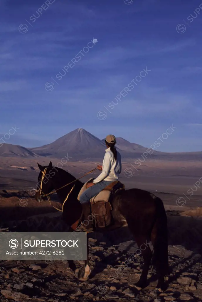 Looking out across the Salt Mountains towards Volcan Licancabur during a horse trek along Las Cornicas ridge