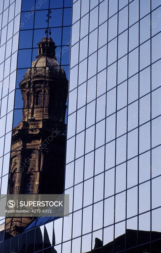 Chile, Santiago. One of the towers on the Metropolitan Cathedral in Santiago is reflected in a nearby office block.