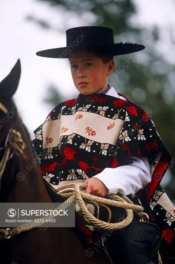 Chile, Region VI, Parral. A young huaso taking part in a regional Rodeo competition.