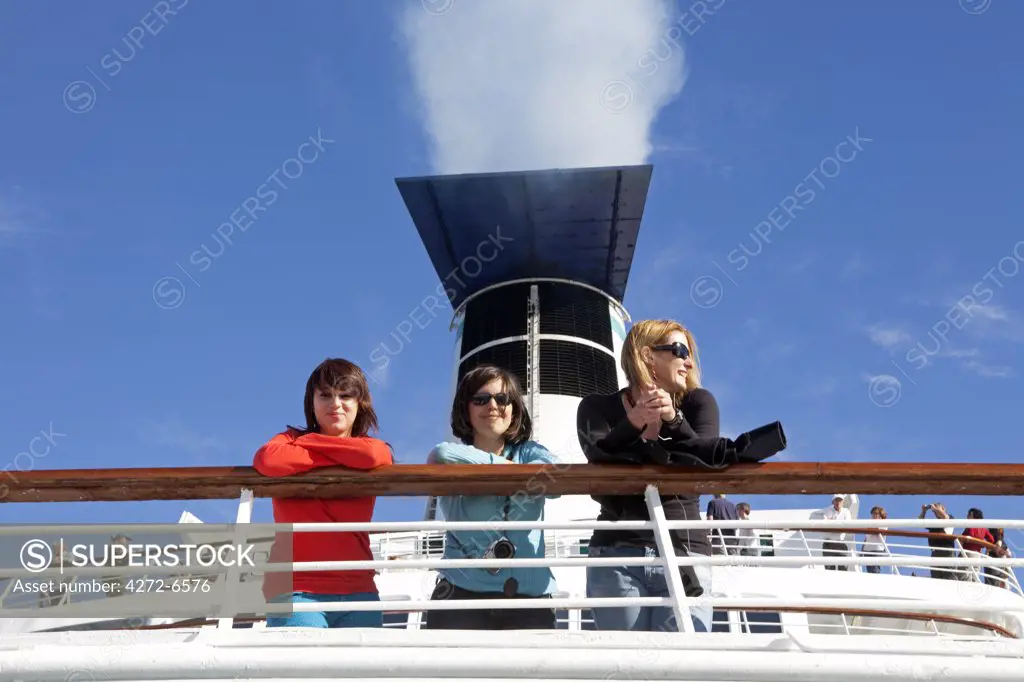 Chile. Three passengers on the MV Discovery Cruise liner.