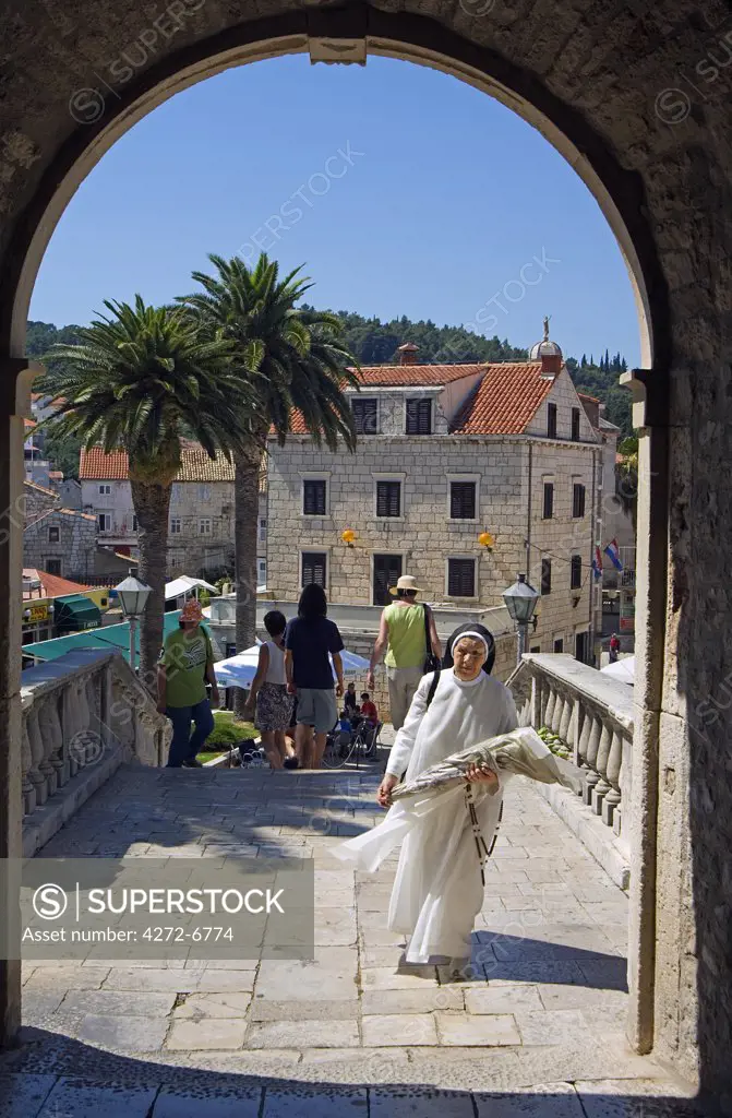 Korcula Island Nun walking through Gate of Medieval Old Town City Wall