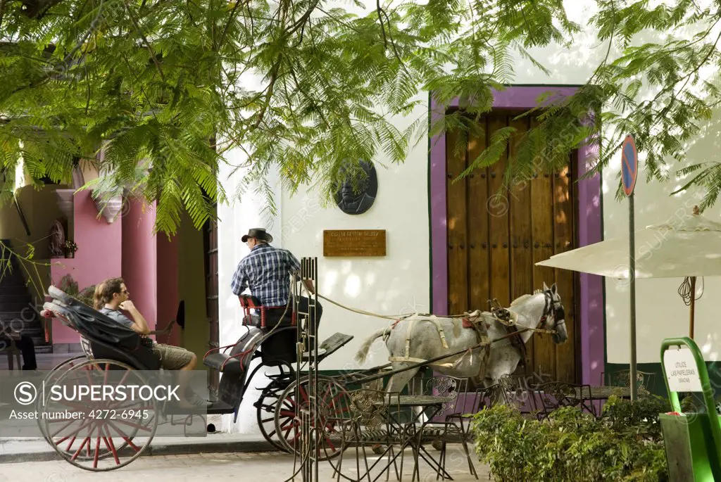 Cuba, Havana. Horse and carriage on Cale Mercaderes, Havana