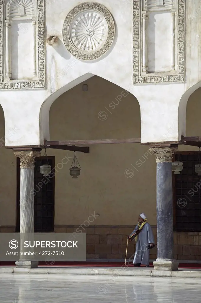 An old Egyptian man walks through the Al Azhar mosque in Cairo.