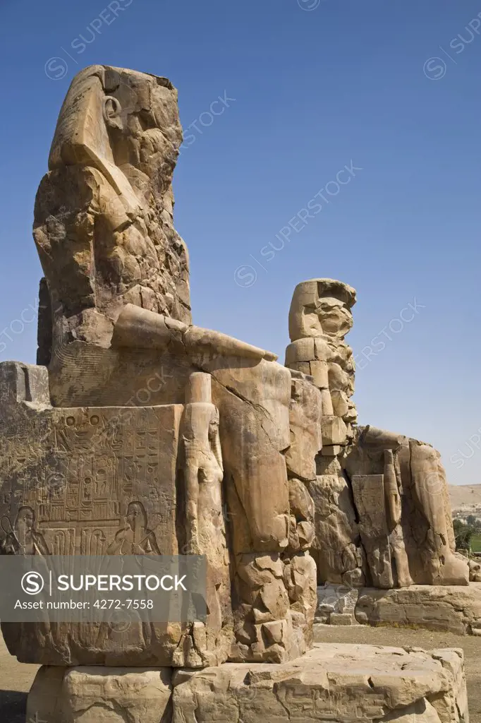 The Colossi of Memnon stand at the entrance to the ancient Theban Necropolis on the West Bank of the Nile at Luxor.
