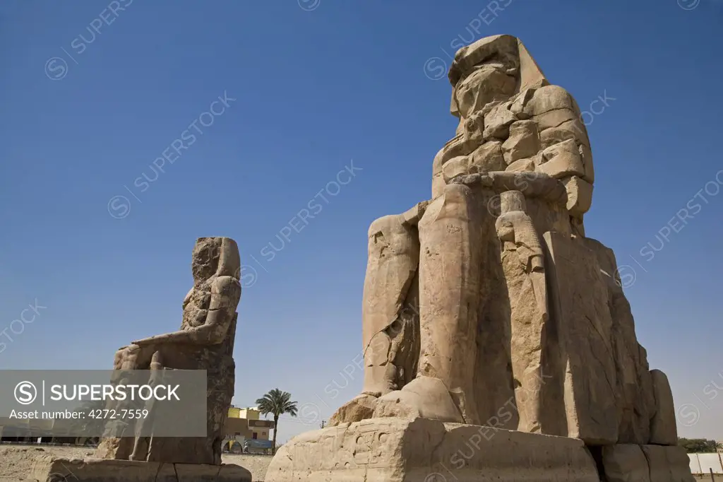 The Colossi of Memnon stand at the entrance to the ancient Theban Necropolis on the West Bank of the Nile at Luxor.