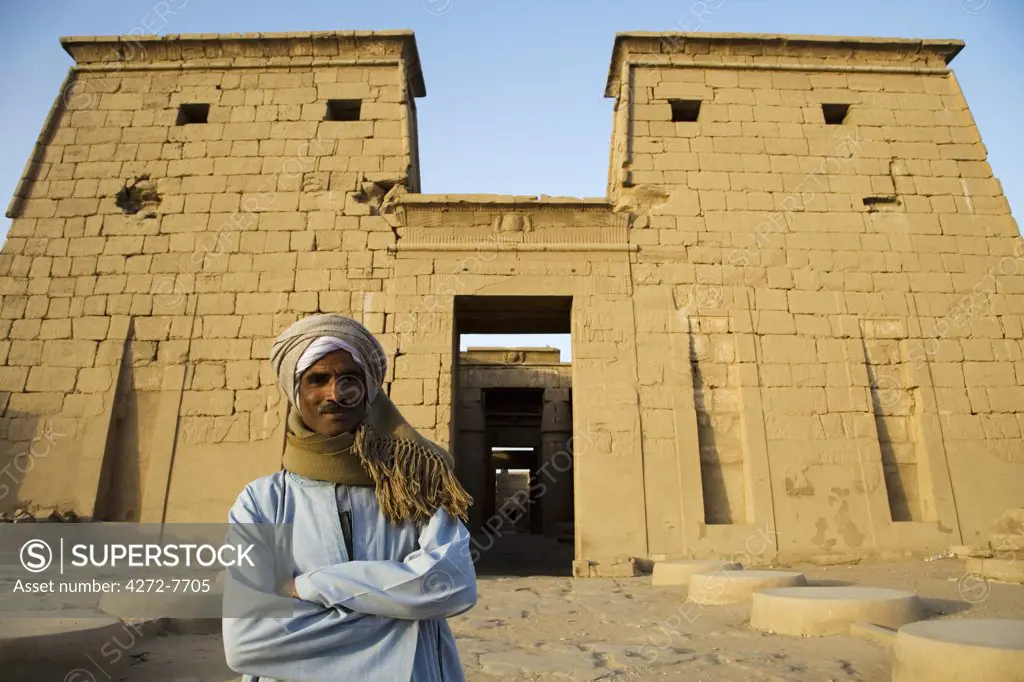 A temple guardian stands in front of the Temple of Khonsu at Karnak Temple, Luxor, Egypt