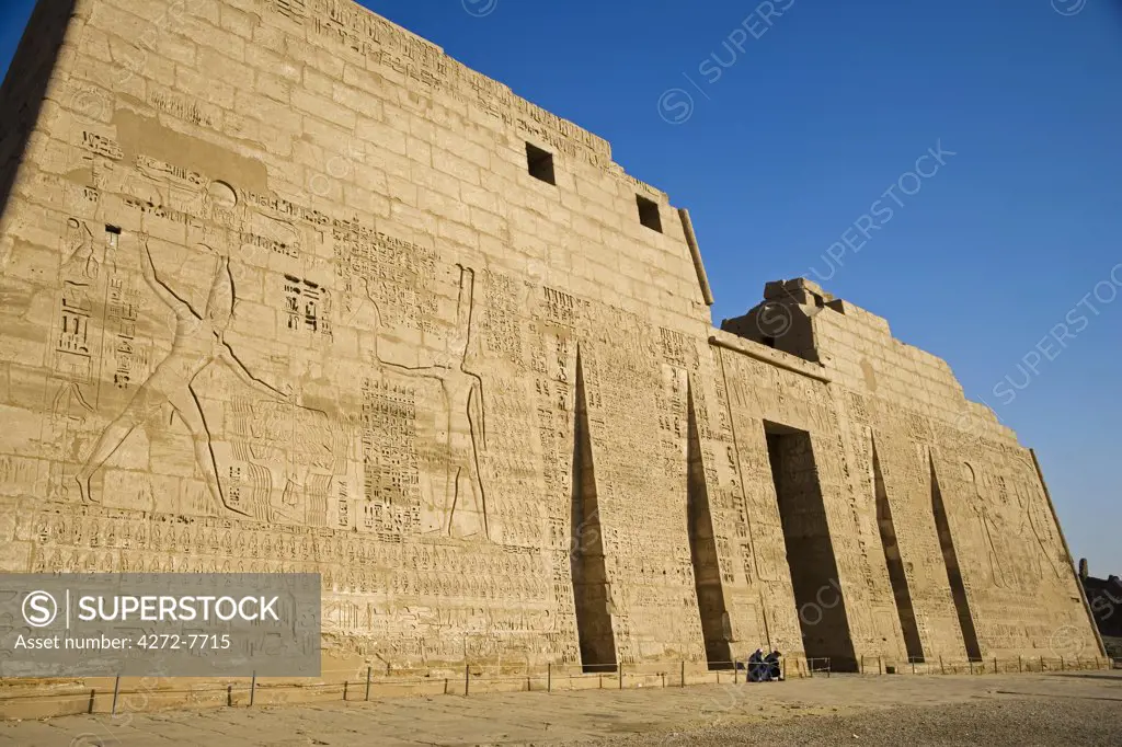 The impressive First Pylon of the wonderfully preserved mortuary temple of Ramses III at Medinet Habu on the West Bank, Luxor, Egypt.