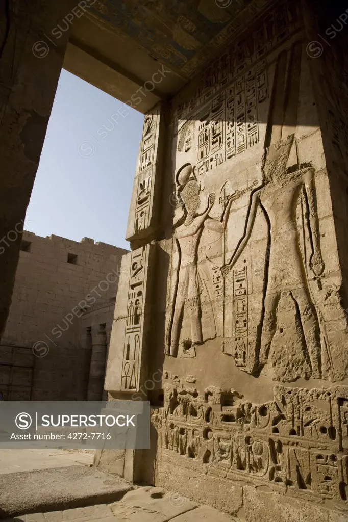 Beautiful carvings and heiroglyphs cover the walls of the mortuary temple of Ramses III at Medinet Habu on the West Bank, Luxor, Egypt.