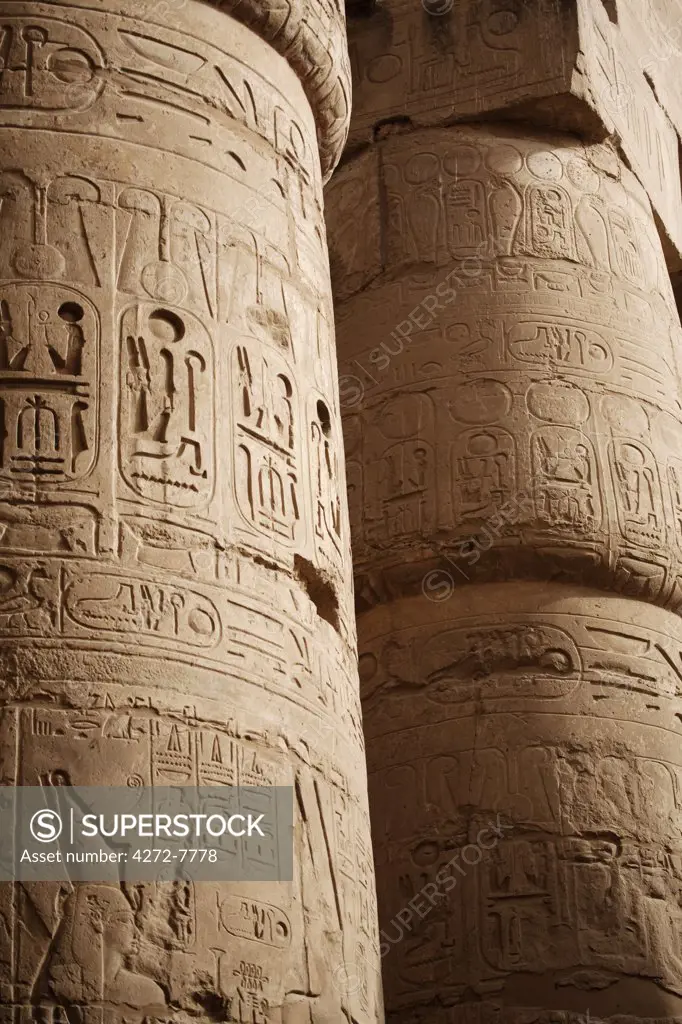 Egypt, Karnak. Hieroglyphics adorn the sides of the massive columns in the Great Hypostyle Hall at Karnak.