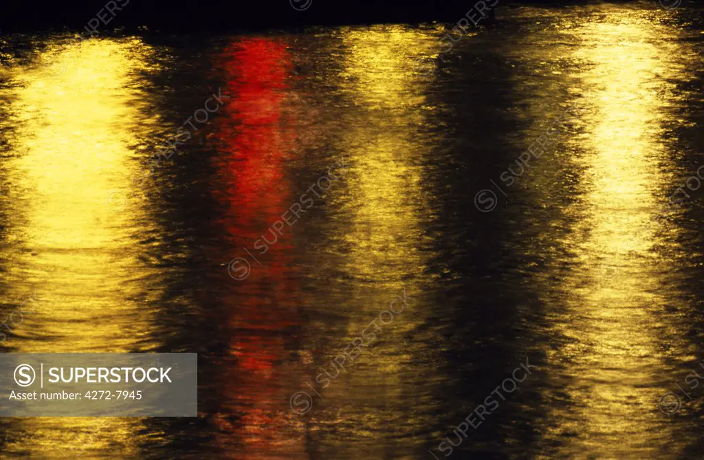 Streel and Traffic lights reflected on the surface of the River Thames at night. Shot from Waterloo Bridge.
