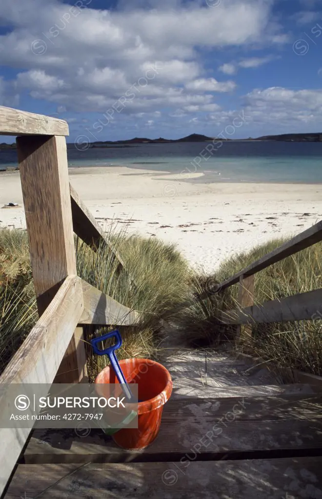A bucket and spade on the steps leading to the beach near Blockhouse Point, Tresco.