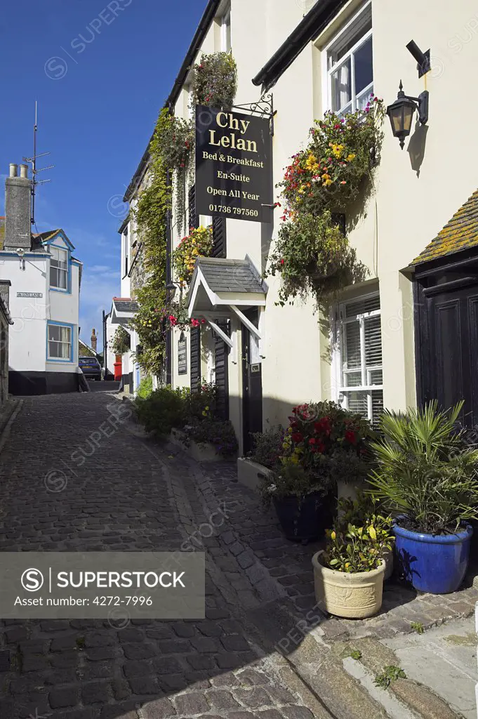 A street in the Fisherman's Quarter of St Ives, Cornwall, lined with B&Bs and hotels. Once the home of one of the largest fishing fleets in Britain, the industry has since gone into decline. Tourism is now the primary industry of this popular seaside resort town.