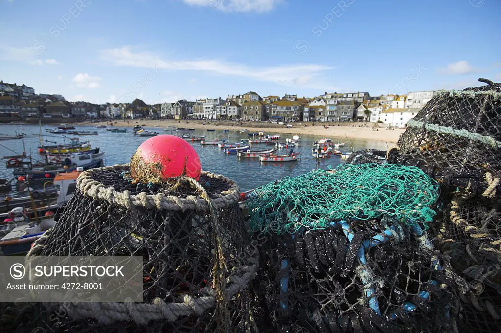Lobster pots on the quayside at St Ives, Cornwall.  Once the home of one of the largest fishing fleets in Britain, the industry has since gone into decline. Tourism is now the primary industry of this popular seaside resort town.