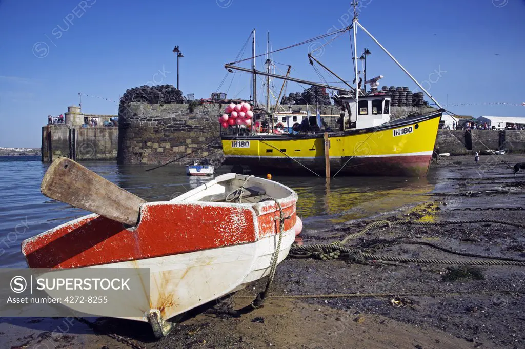 Fishing boats in Newquay harbour at low tide.