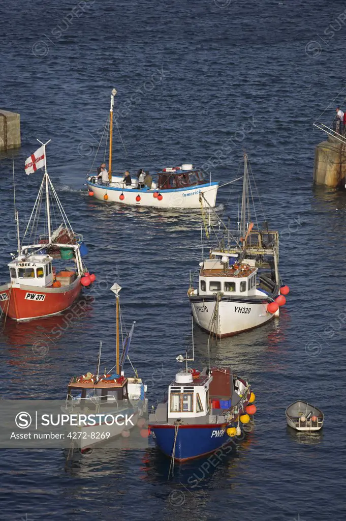 Fishing boats in Newquay harbour at high tide.