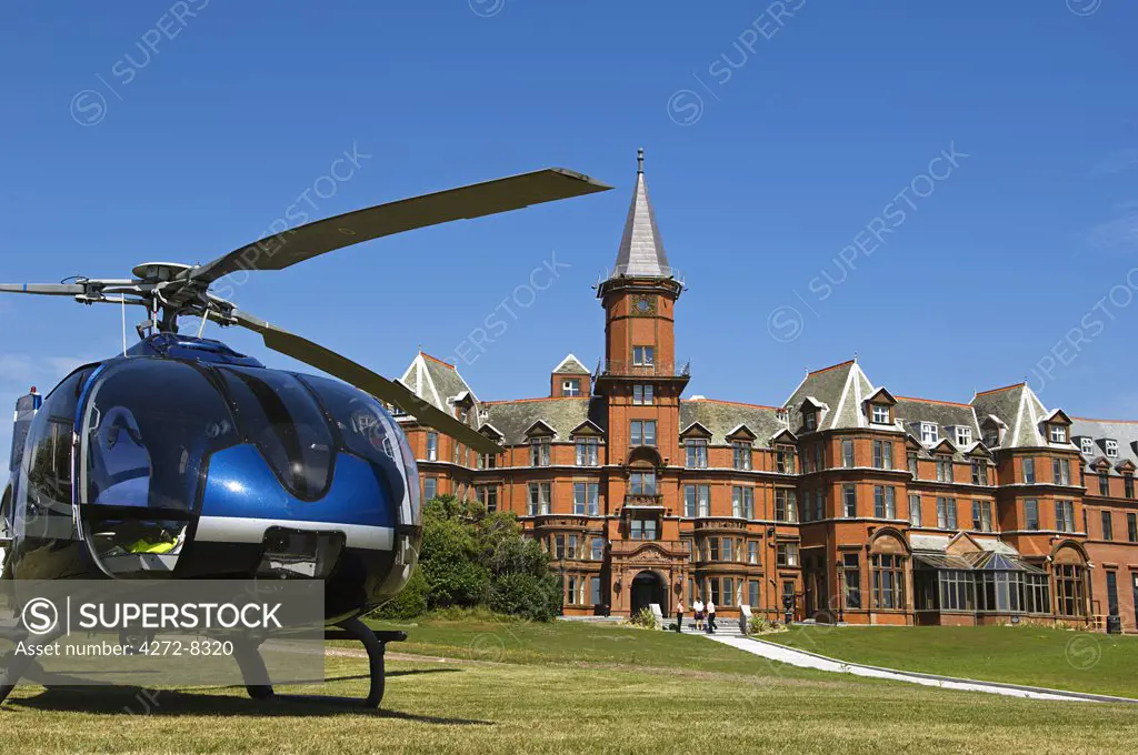 A helicopter waits to pick up guests from the Slieve Donard Hotel, at the small coastal town of Newcastle.