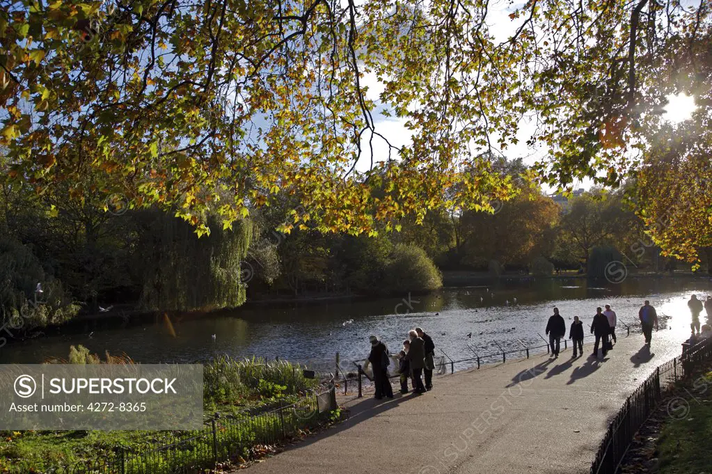 People enjoying a stroll in St James's Park in Autumn