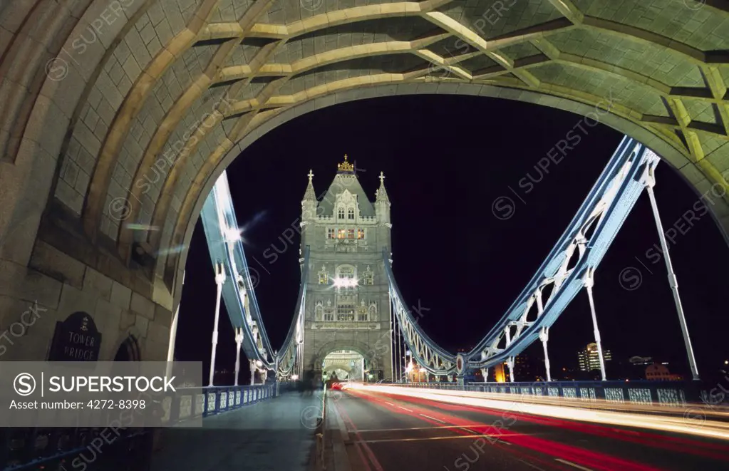 Night time traffic crosses Tower Bridge in central London. Built in 1894, the iconic bridge was designed to rise and allow ship to pass through.