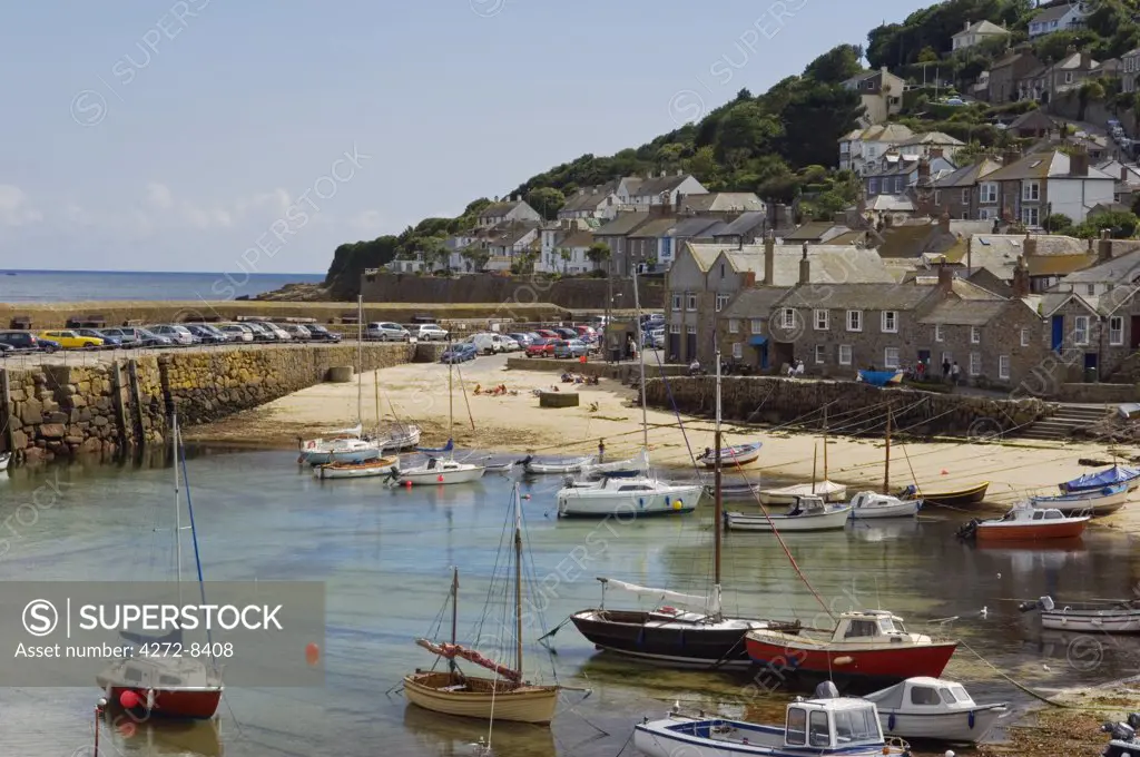 Boats moored in the harbour of the old Cornish fishing village of Mousehole, Cornwall, England