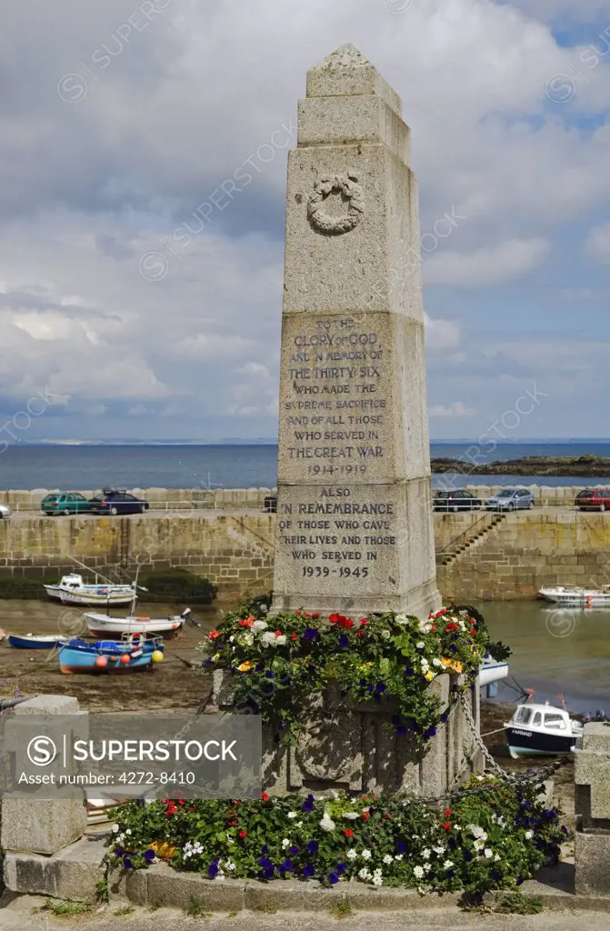 The war memorial in the Cornish village of Mousehole looks out over the harbour, Cornwall, England